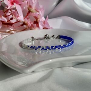 Constellations est un bracelet fin tissé à la main en perles Miyuki bleu profond et argent. Un bijou lumineux et graphique, inspiré par le ciel étoilé et la magie des nuits claires.